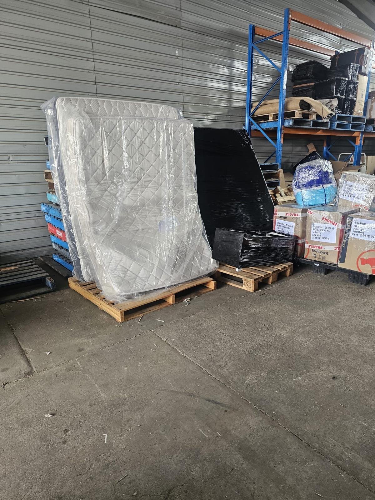 Wrapped mattress and furniture ready for freight